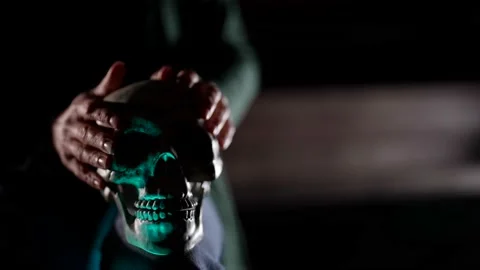 Close-up of a hand holding a human skull. A fortune teller performing a ritual Video stock 164240095