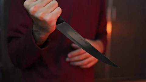 Close Up of Hand Holding Kitchen Knife with Blurred Background Stock Footage 337847344