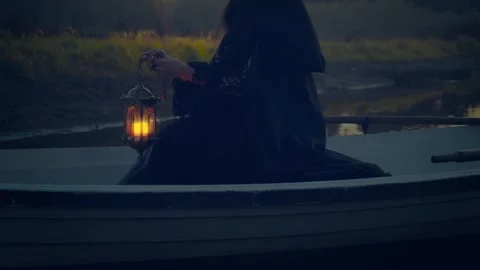Close-up hand holding lantern with warm light, fantasy gothic woman witch Stock Footage 318901466