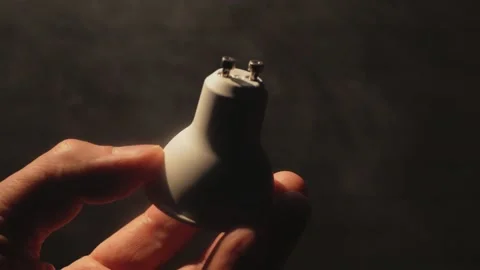 Close-up hand holding a light bulb in the dark. Stock Footage 165596611