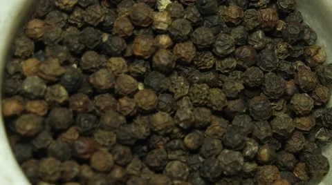 Close-up hand holding a marble mortar of whole black pepper spices Stock Footage 68770928
