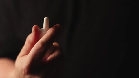 Close-up of hand holding a nasal spray bottle for medication administration Stock Footage 340267243