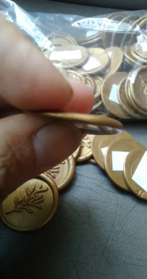Close up of hand holding old coins with tree symbol. Stock Footage 339308378