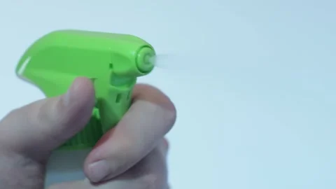 Close up of hand holding pulverizer spraying water Stock Footage 134069661
