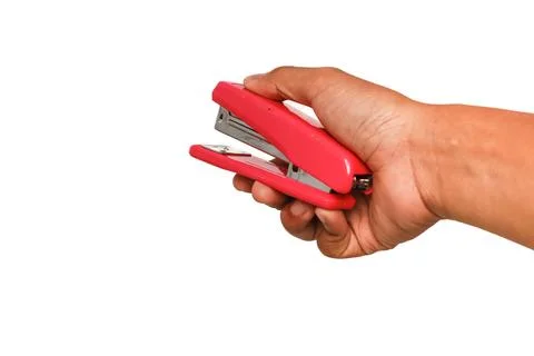 Close-up of a hand holding a red stapler ready to staple papers, isolated o.. Stock Photos