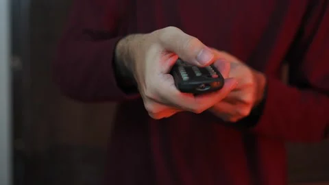 Close Up of Hand Holding Remote Control Pointing Forward Stock Footage 337847373