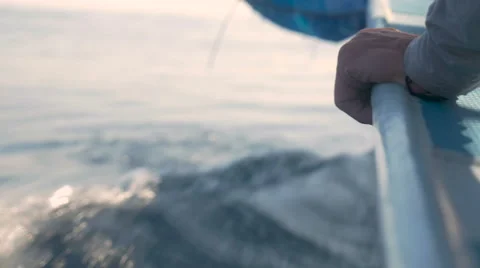 Close up of a hand holding the side of a boat as it speeds through water 스톡 동영상 57103829