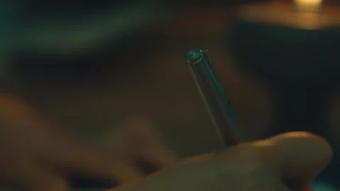Close-up of Hand Holding Silver Pen Tip Against Blurred Background Stock Footage 337424831