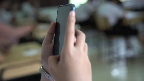Close up hand holding smart phone in room and blurred background Видео 144746377