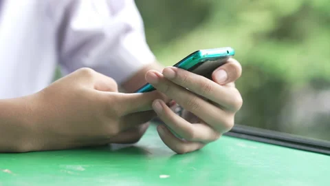 Close up hand holding smart phone for use searching data to learning in class 動画素材 217385065