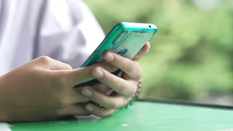 Close up hand holding smart phone for use searching data to learning in class Stock Footage 217385261