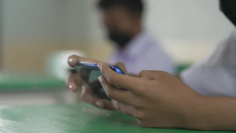 Close up hand holding smart phone for use searching data to learning in class Vídeos de archivo 217388360