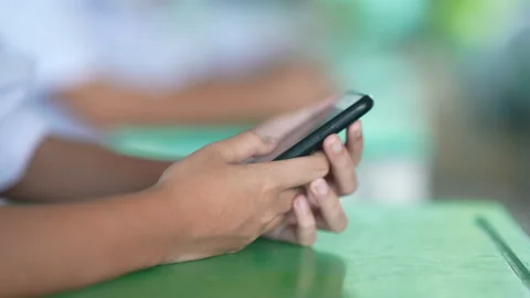 Close up hand holding smart phone for use searching data to learning in class 動画素材 217866237