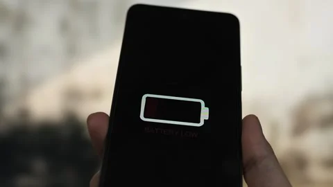 Close up of hand holding smart phone with low battery icon on screen. indoor Stock Footage 340509949