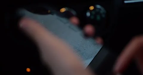 Close-up of a hand holding a smartphone inside a car at night, showing a... Stock Footage 319882573