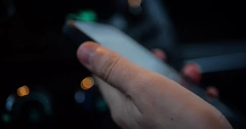 Close-up of a hand holding a smartphone inside a car at night... Stock Footage 319882718