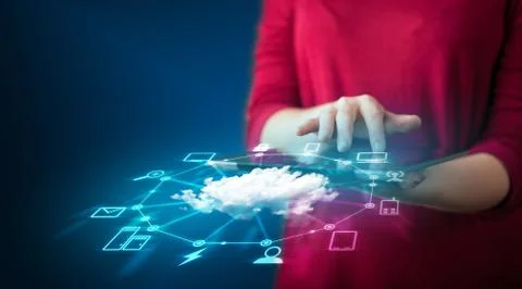Close up of hand holding tablet with cloud network technology Stock Photos