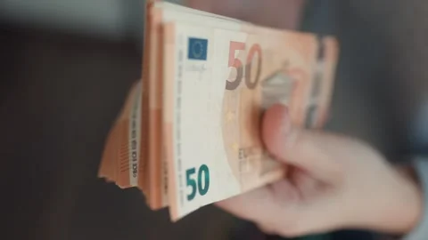 Close Up Hand Holding Thick Stack Of Orange Fifty Euro Banknotes Vídeos de archivo 333995194