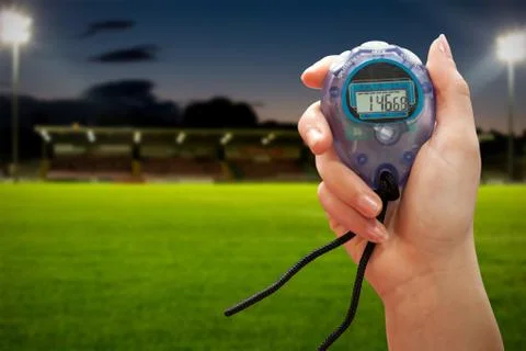 Close up of a hand holding a timer against pitch Stock Photos