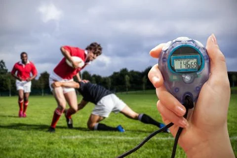 Close up of a hand holding a timer during a rugby match Stock Photos