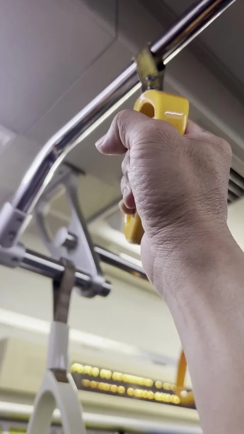 Close Up Hand Holding Train Handrail Inside Commuter Train in Jakarta Stock Footage 336979060