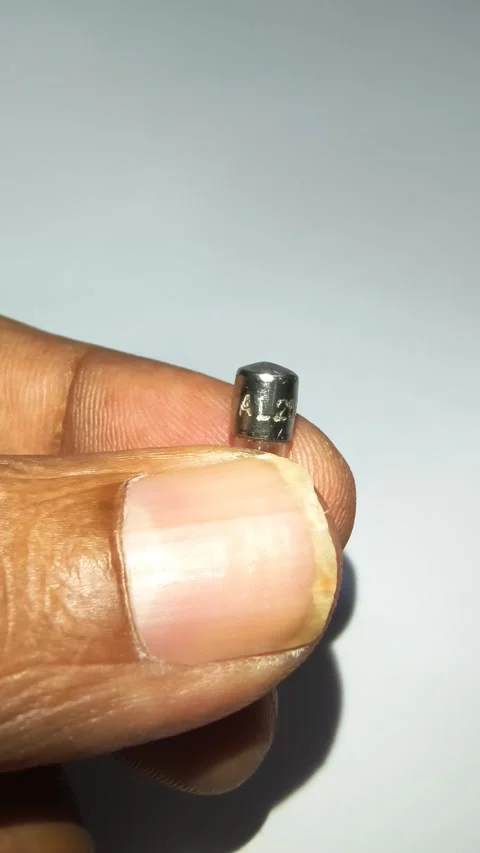 Close up of hand holding transparent 5A glass cartridge fuse for visual check. Stock Footage 344092027