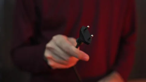 Close Up of Hand Holding Two Pin AC Power Plug with Blurred Background Stock-Footage 337847362