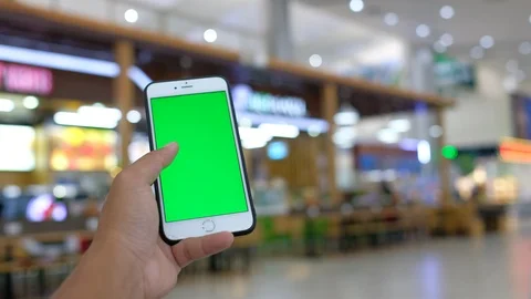 Close up hand holding using a mobile smartphone green screen Stock Footage 99043186