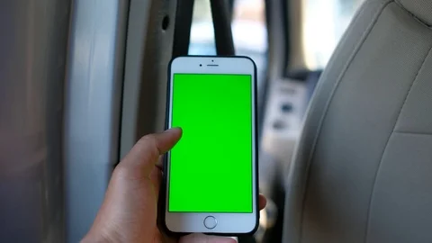 Close up hand holding using mobile smart phone green screen in car Stock Footage 99044682