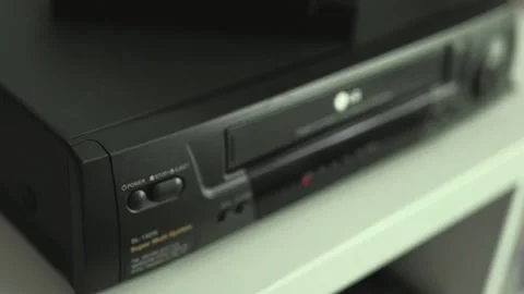 Close up of a hand holding a videotape. Retro vhs cassete in a player. Stock-Footage 286426251