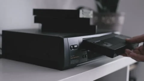 Close up of a hand holding a videotape. Retro vhs cassete in a player. Stock-Footage 286426334
