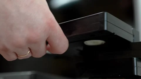 Close up of a hand holding a videotape. Retro vhs cassete in a player. Stock-Footage 286426601
