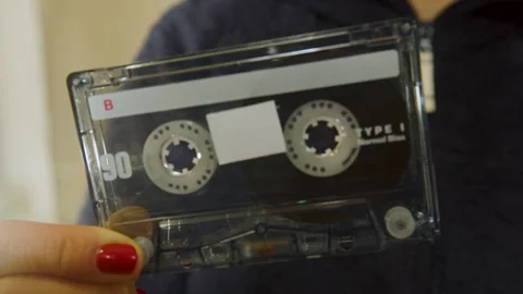 Close-up of a hand holding a vintage audio cassette tape Stock Footage 327687611