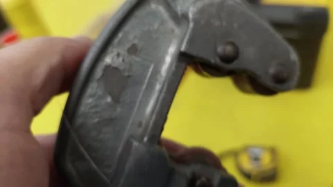 Close-up of a hand holding a vintage pipe cutter tool Stock Footage 336460615