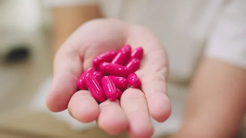 Close-Up of Hand Holding Vitamins Capsules in their Hand. Stock Footage 341230322