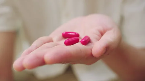 Close-Up of Hand Holding Vitamins Capsules in their Hand. Stock Footage 341230414