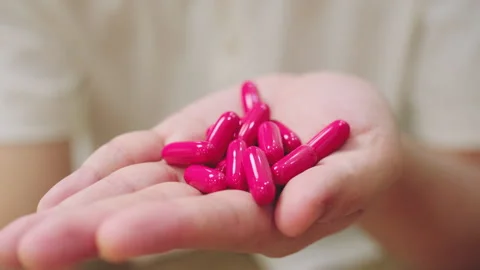 Close-Up of Hand Holding Vitamins Capsules in their Hand. Stock Footage 341231049