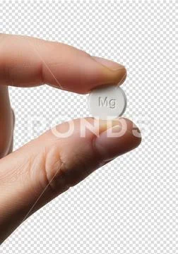 Close-up of hand holding white magnesium supplement tablet PSD Template