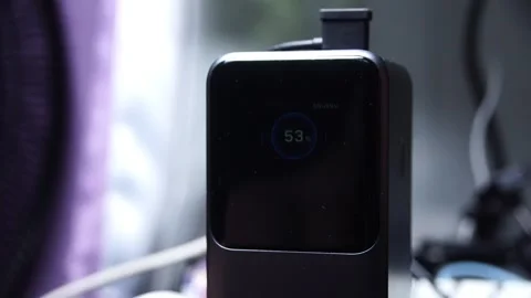 Close-up: Hand holds black device with digital "53" display Stock Footage 342122864