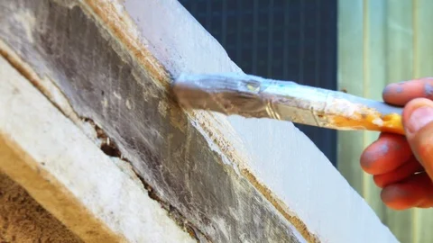 Close-up hand holds rolling paint brush Stock-Footage 116269780
