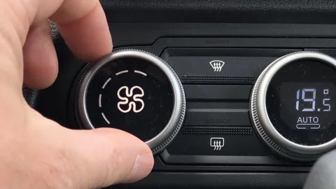 Close up of hand increasing car air conditioner fan speed using control knob Видео 333307238