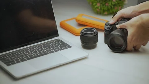 Close up of hand insert the MMC card into the professional camera Video stock 128406585