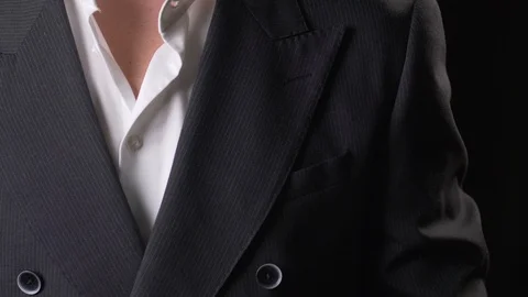 Close-up of a hand insert a scarf in a pocket Stock Footage 119321869