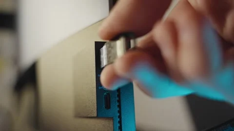 Close up hand inserting or plugging usb drive or memory stick into computer Stock Footage 337012636
