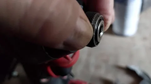 Close-up of a hand inserting or releasing a quick release chuck mechanism on a p Vídeo Stock 336487752
