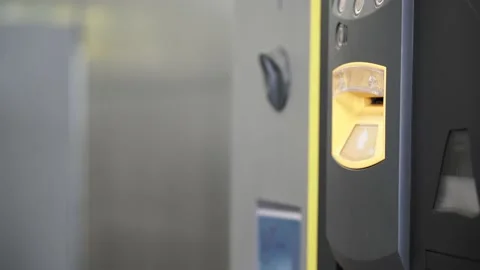 Close up of a hand inserting in a parking ticket into a machine to pay the ai 스톡 동영상 136393523
