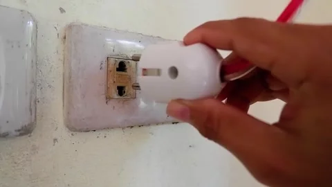 Close Up Of A Hand Inserting A Safety Plug Into A Wall Socket Stock Footage 292588605