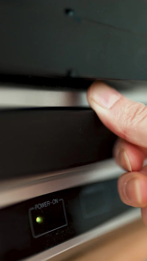 Close up of a hand inserting a VHS video cassette into a vintage VCR player, 4K  Stock Footage 330677384