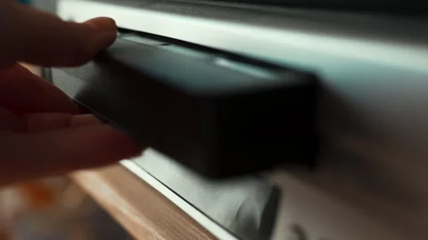 Close up of a hand inserting a VHS video cassette into a vintage VCR player, 4K  Stock Footage 330677928