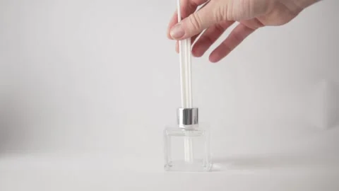 Close-up, the hand inserts wooden sticks into the flavor with liquid Stock Footage 161892555